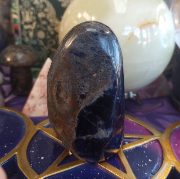 Polished stone on a decorative surface with blurred background